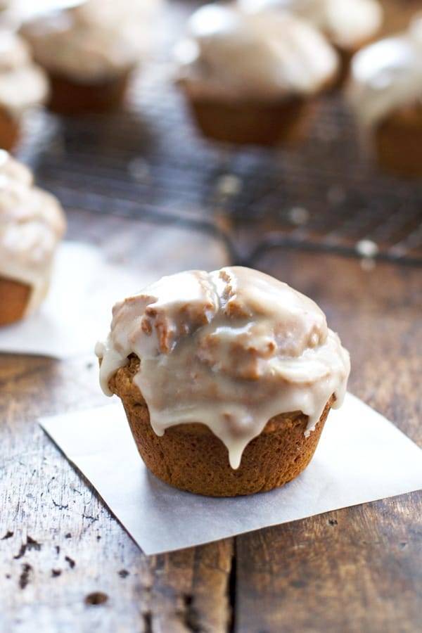 One Maple Glazed Pumpkin Muffin on parchment paper.