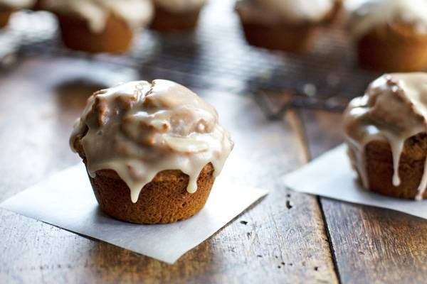 Maple Glazed Pumpkin Muffins on parchment paper.