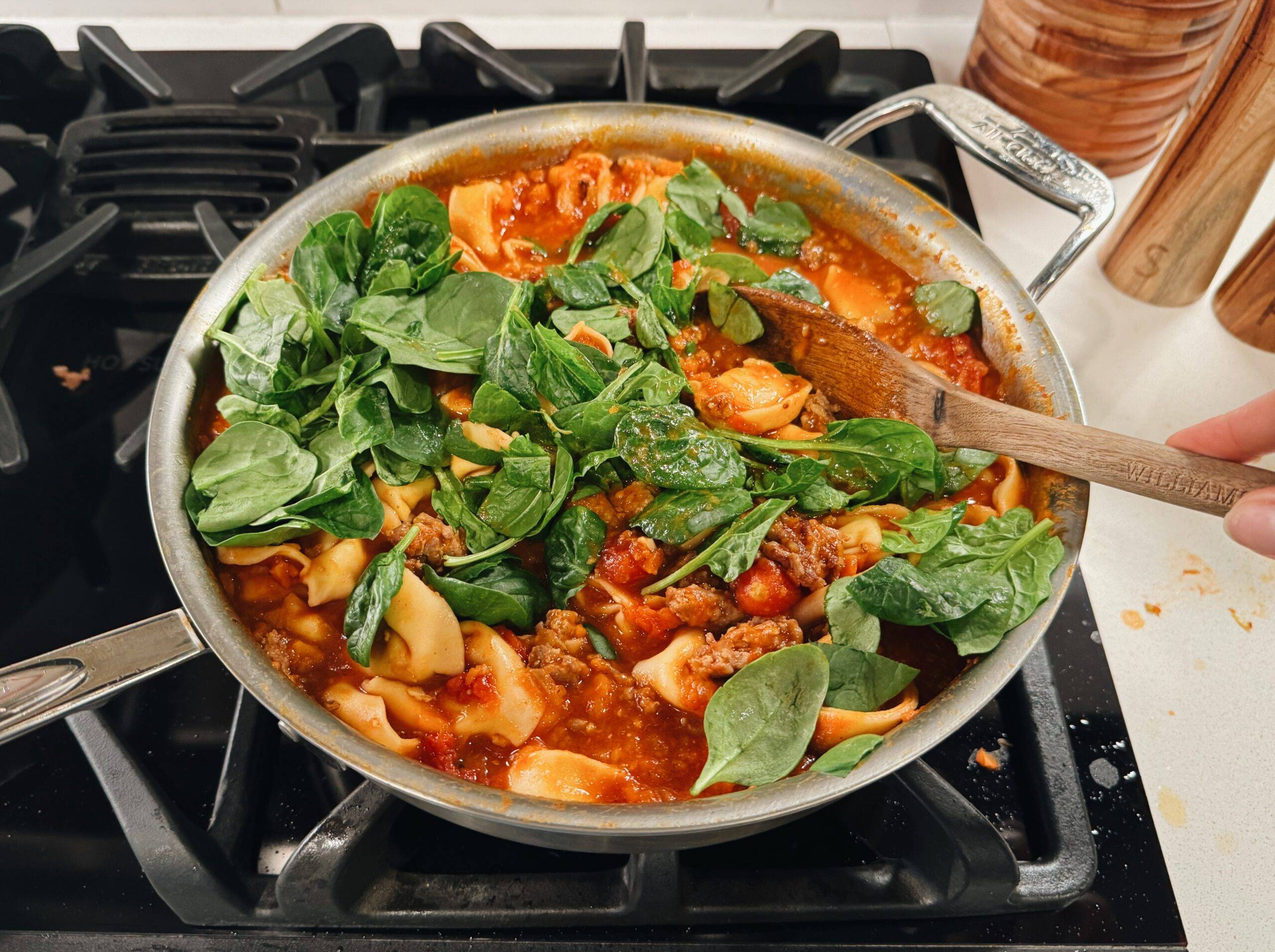 Adding spinach to the tortellini 