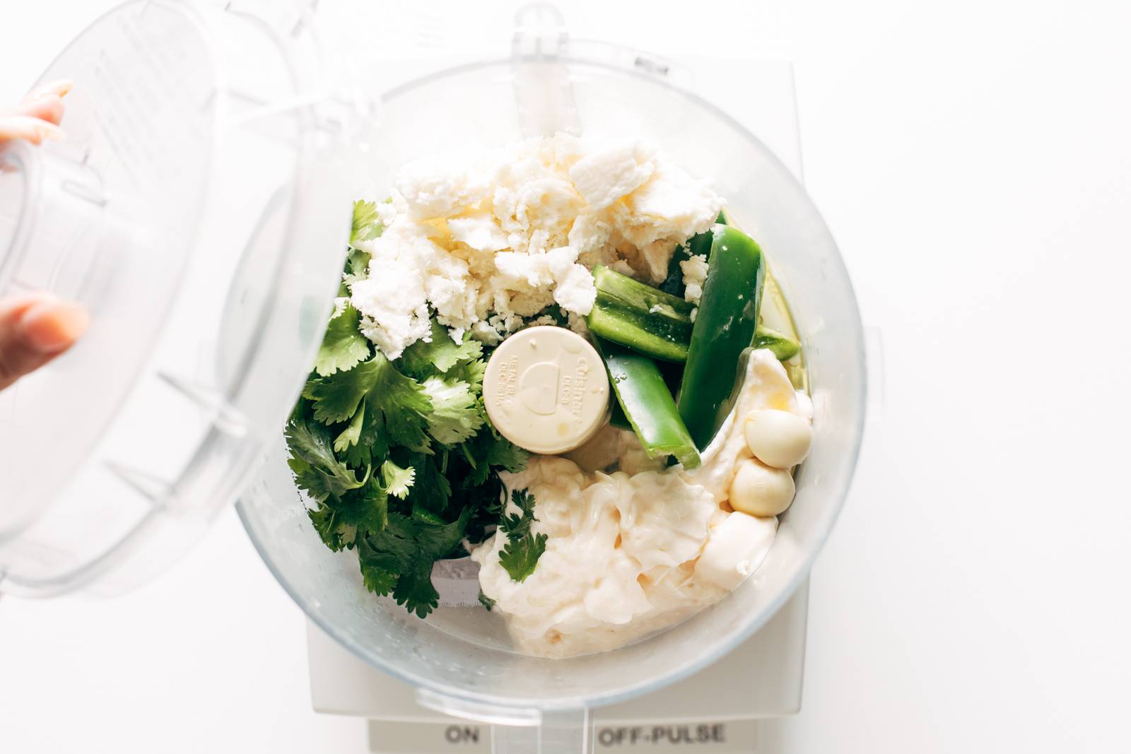 Ingredients for aji verde added to a food processor.