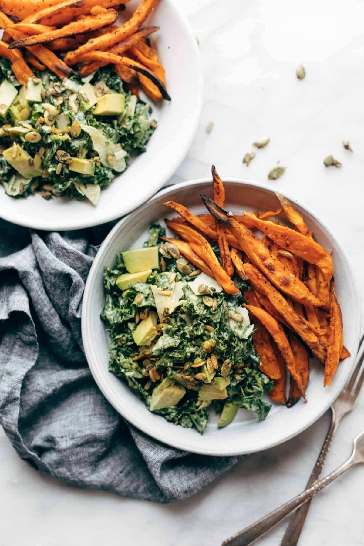 Avocado caesar salad with sweet potato fries.