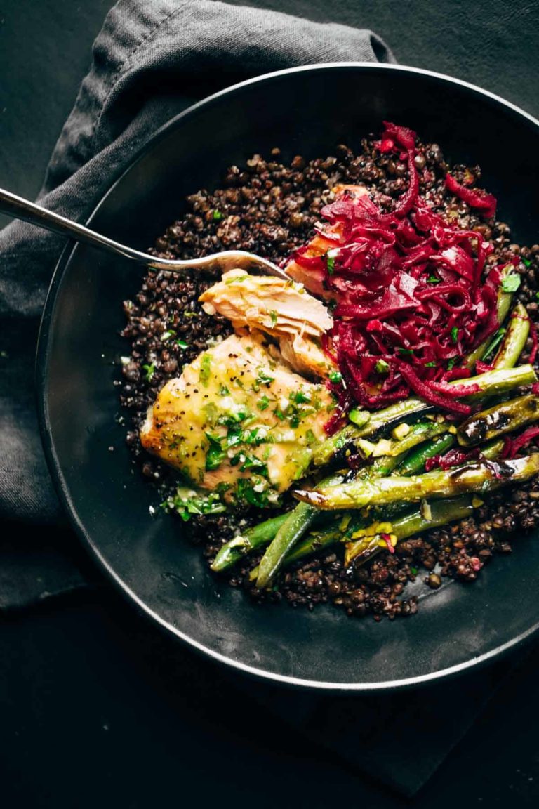 Baked salmon with lentils, green beans, and sauerkraut in bowl.