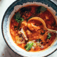 Spoon in bowl of tomato and bread soup