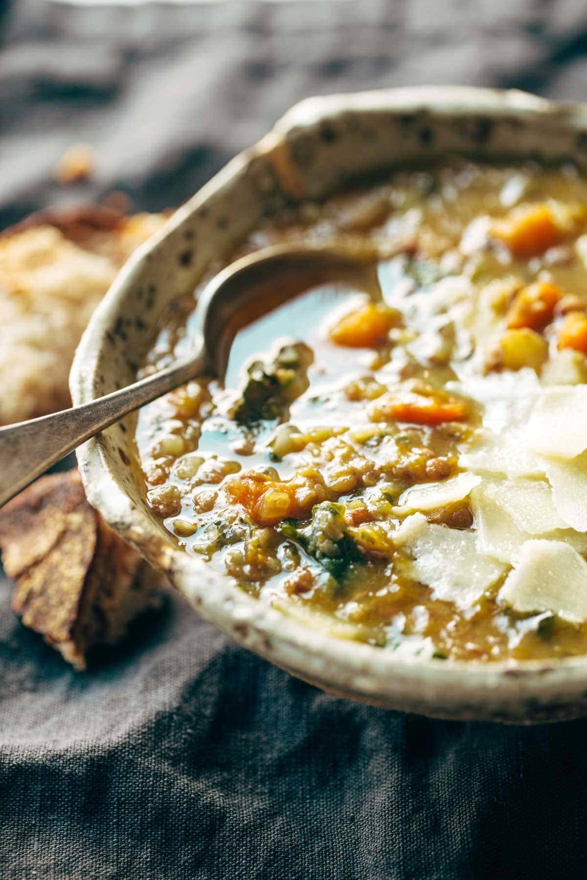 Lentil soup in a bowl with a spoon.