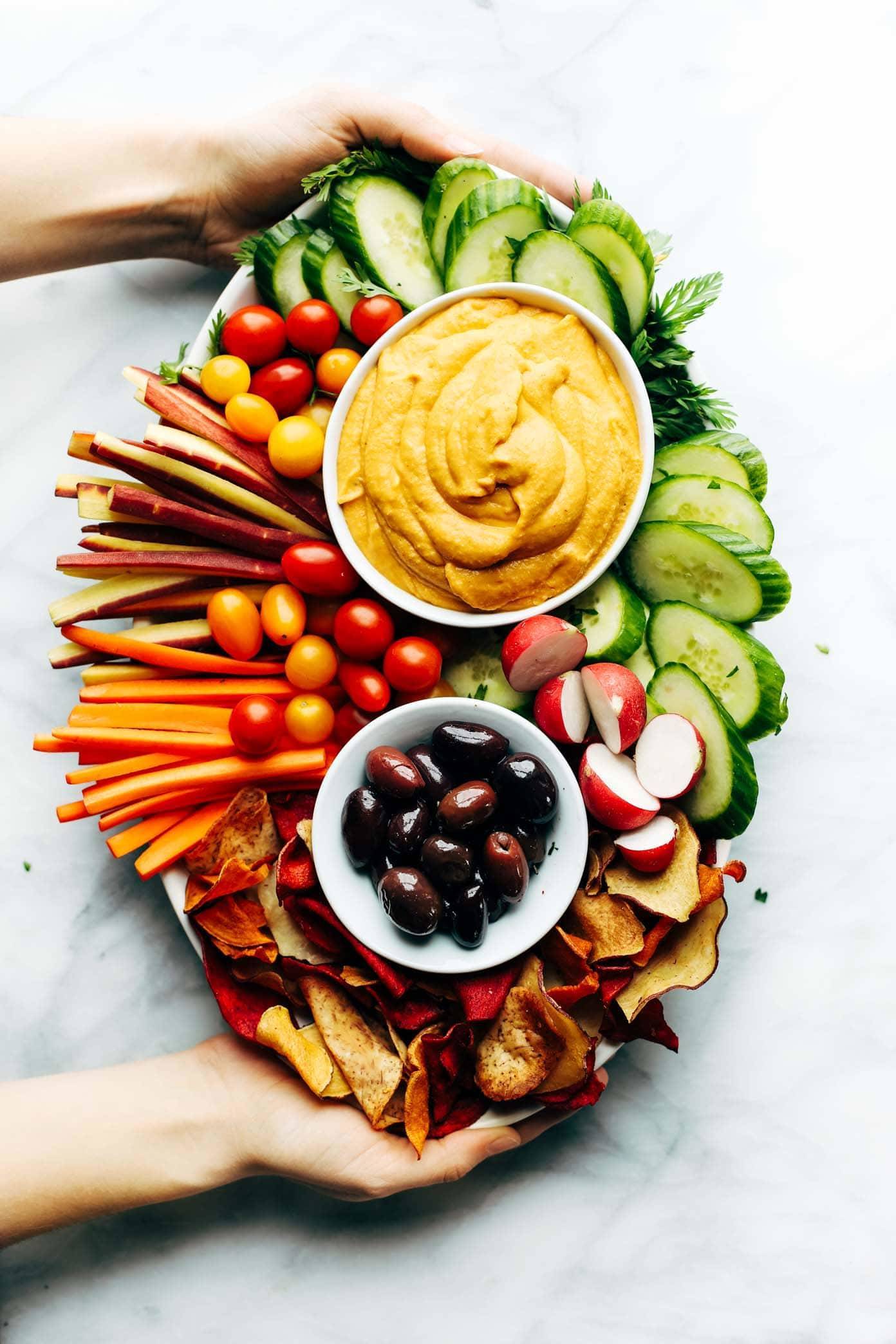 Curry Hummus on a plate with vegetables.