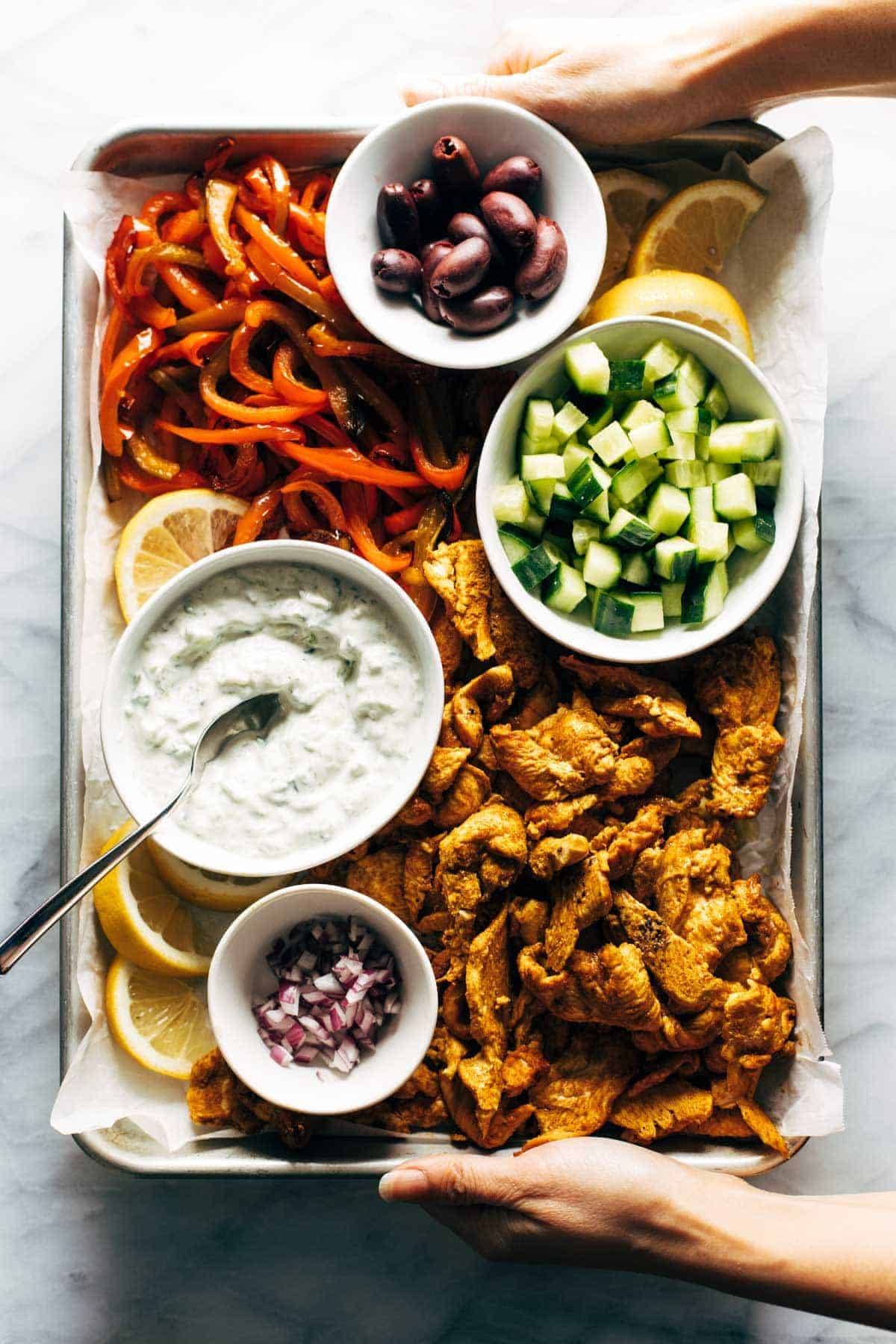 Chicken, veggies, and toppings for sheet pan pitas.