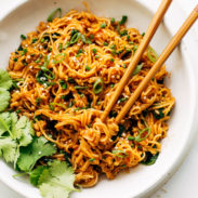 Bowl of gochujang noodles with chopsticks.