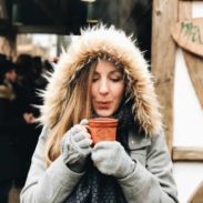 Lindsay holding a mug of mulled wine.