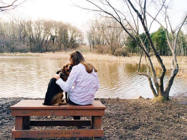 Woman and dog at the dog park.