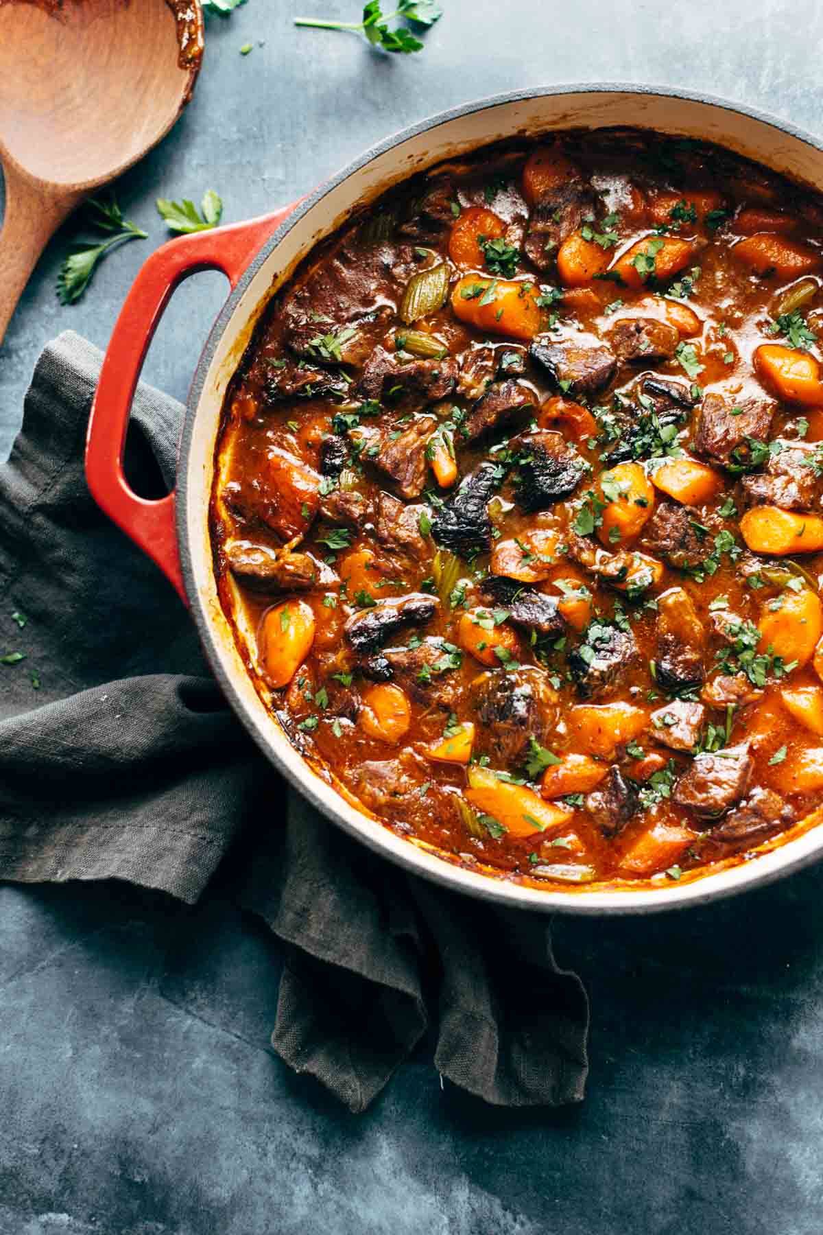 A pot of stew on a blue tablecloth.