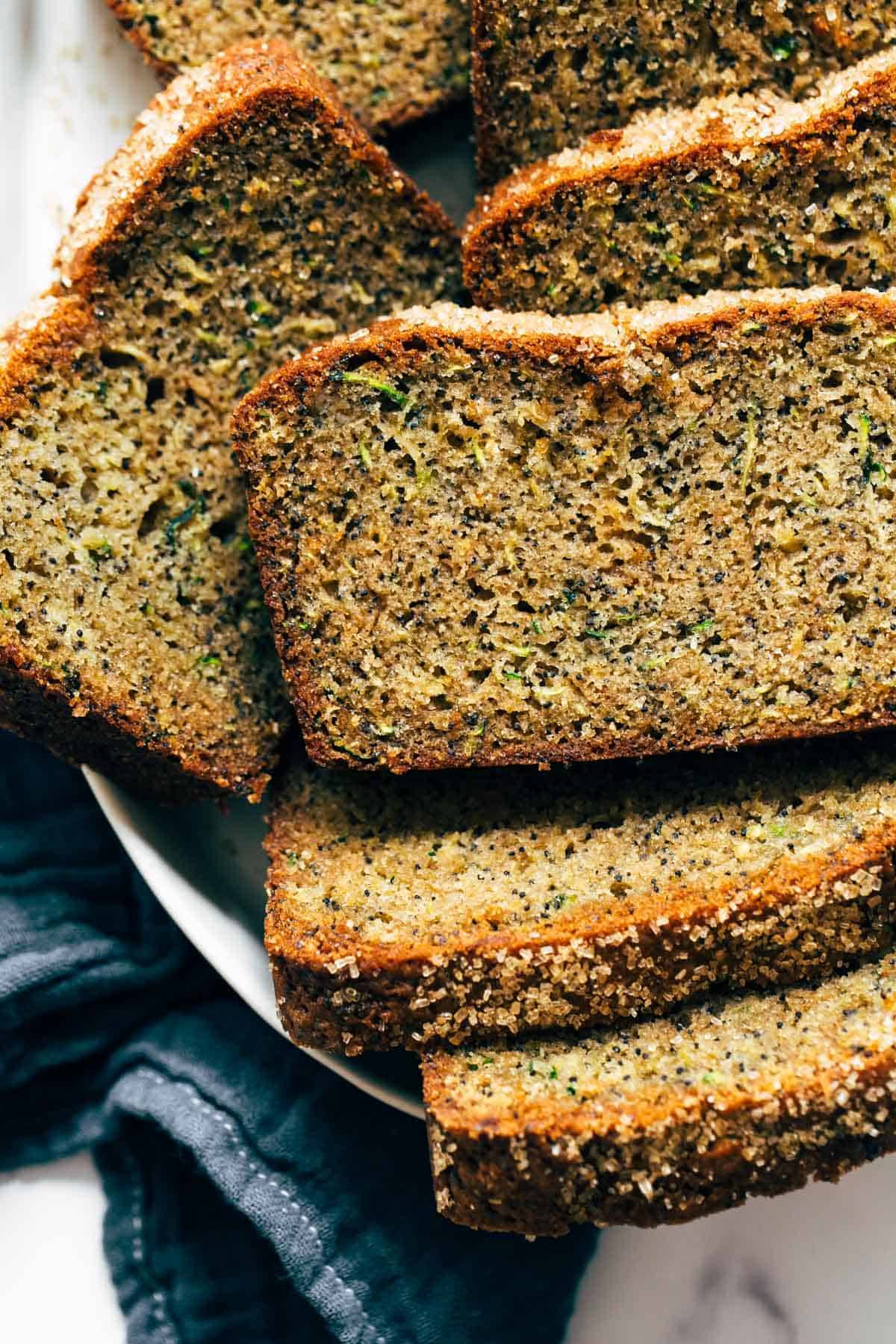 Lemon Poppyseed Zucchini Bread stacked on a plate.