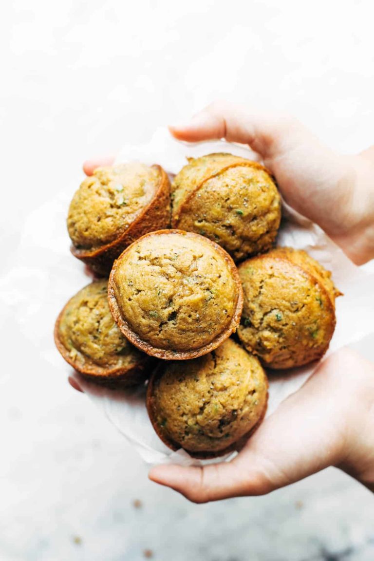 Lemon Zucchini Muffins held by hands.