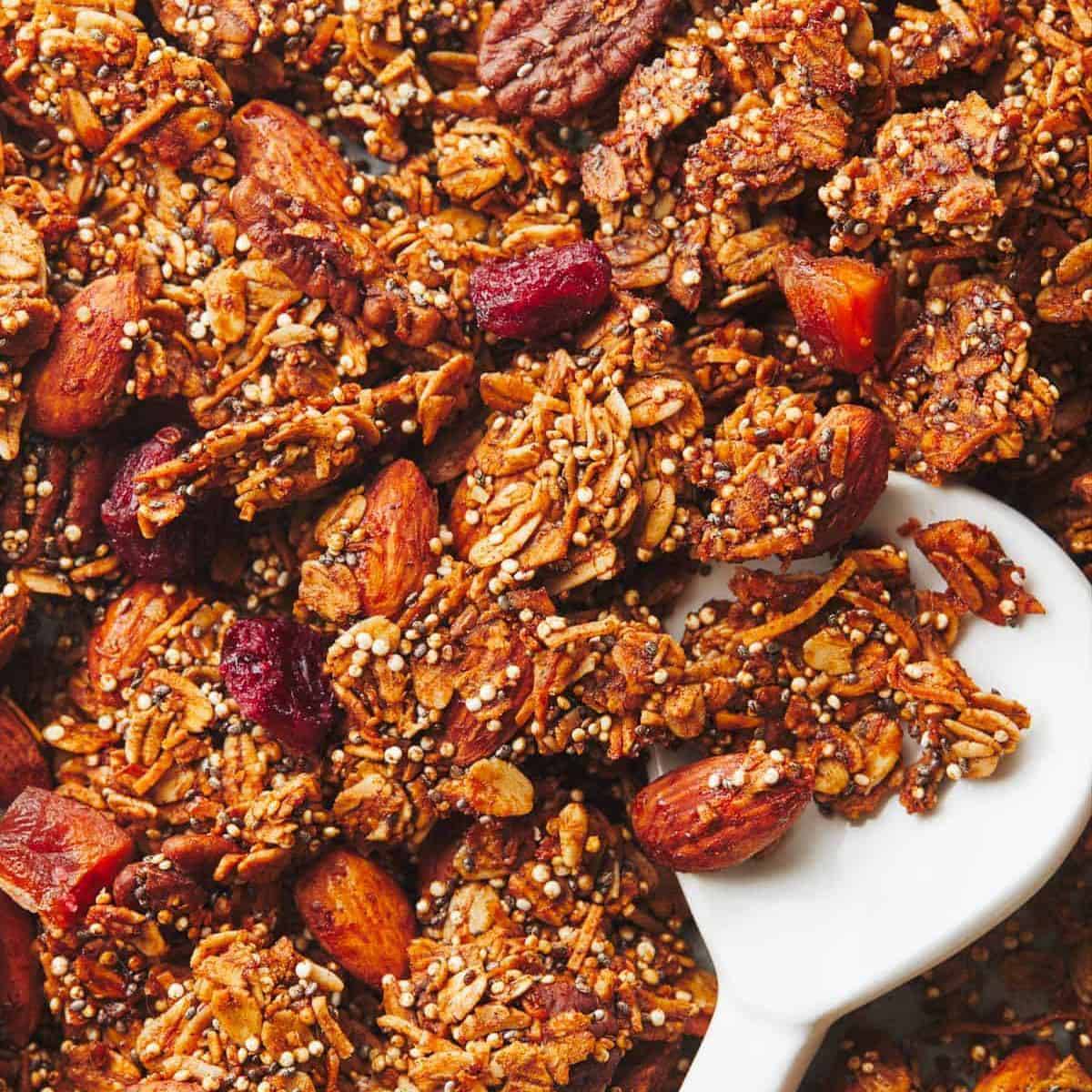 Maple quinoa granola with a serving spoon.