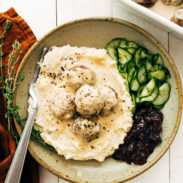 Swedish meatballs with cucumbers and cranberries in a bowl.