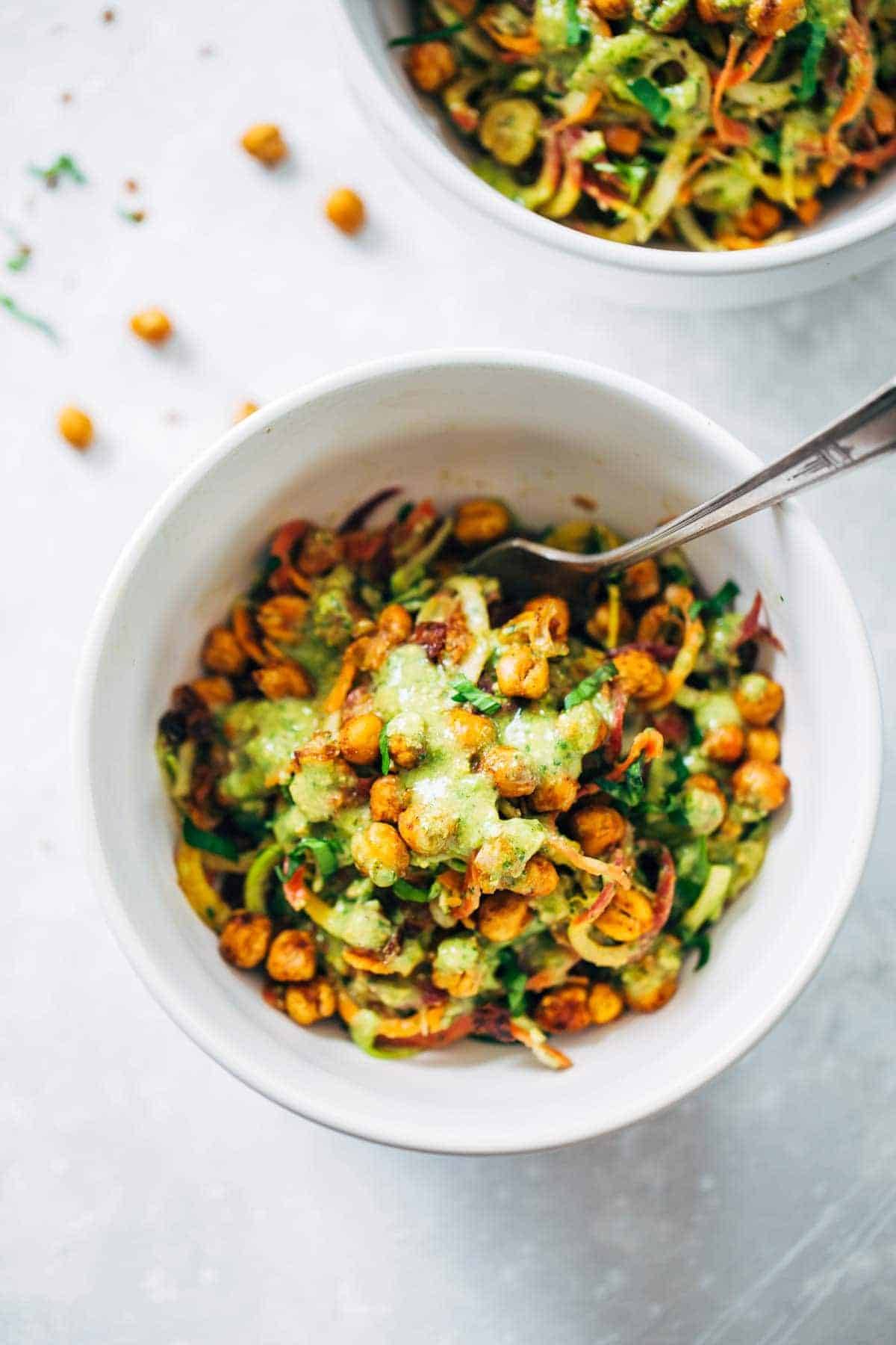 Rainbow Power Salad with Roasted Chickpeas in a white bowl with a fork.