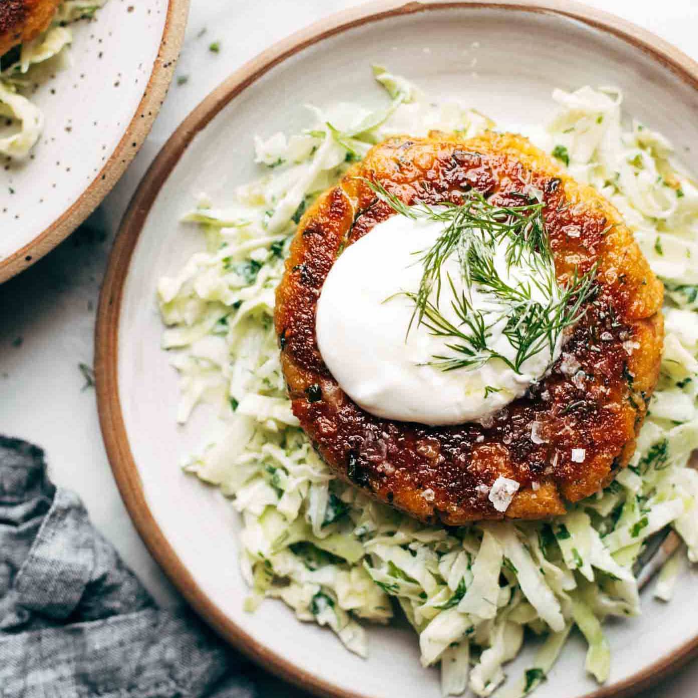 Salmon Burger on plate with slaw.